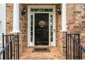 Inviting front entrance with a black door, white columns, and decorative welcome sign at 3220 Millwood Se Trl, Smyrna, GA 30080