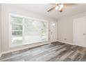 Inviting living room with a large window offering plenty of natural light and gray wood-look flooring at 823 Catherine St, Forest Park, GA 30297