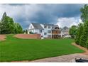 Expansive backyard with lush greenery and a charming patio, perfect for outdoor entertaining and relaxation at 100 Ashley Hall Ct, Woodstock, GA 30188