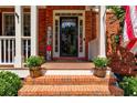 Welcoming front porch with brick steps, potted plants, and a 'Welcome' sign at 1120 Bentwater Dr, Acworth, GA 30101
