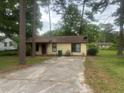 Inviting single-story home with mature trees, a well-maintained yard, and a concrete driveway at 1253 Todiway Ct, Jonesboro, GA 30238