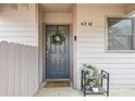 Inviting front door with a wreath and a 'Hello Sunshine' welcome mat, and potted plants at 4216 Stillwater Dr, Duluth, GA 30096