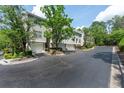 View of a modern townhome complex with well-maintained landscaping and private garages at 4252 River Green Dr # 501, Atlanta, GA 30327