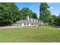 Inviting home with attached garage and well-maintained lawn, perfect for Gathering living and outdoor activities at 710 Crab Orchard Ct, Roswell, GA 30076