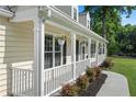 Charming porch with white railings and decorative flower baskets creating a welcoming outdoor space at 710 Crab Orchard Ct, Roswell, GA 30076