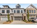 New construction townhomes with brick and siding exteriors, two-car garages, and professionally landscaped front yards at 1070 Harper Dr, Alpharetta, GA 30076