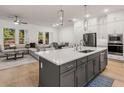 This kitchen has a kitchen island, recessed lights, stainless steel appliances, and overlooks the living area at 1070 Harper Dr, Alpharetta, GA 30076