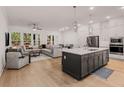 Open concept living space with a kitchen island, living room and plenty of natural light from the large windows at 1070 Harper Dr, Alpharetta, GA 30076