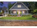 Beautifully landscaped front yard leading to a charming craftsman-style home with a welcoming porch at 1402 Sw Belmont Sw Ave, Atlanta, GA 30310
