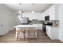 Modern kitchen with white cabinets, stainless steel appliances, and a center island with barstool seating at 1724 Gunnin Nw Trce # 232, Atlanta, GA 30318