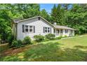 Traditional home with white siding, complemented by dark shutters and a neatly landscaped front yard at 1824 Mcclung Rd, Hiram, GA 30141