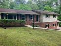 A two-story home boasts brick accents, siding, a well-kept lawn, and a charming front entrance at 215 N Etowah Ct, Canton, GA 30114