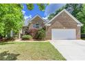 Charming brick home with a two-car garage and a well-manicured front yard beneath a blue sky at 3314 Dilmus Dr, Powder Springs, GA 30127