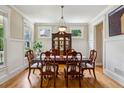 Elegant dining room featuring hardwood floors, wainscoting, and a stylish chandelier above the dining table at 2078 Marshalls Se Ln, Atlanta, GA 30316