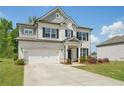 Charming two-story home with a white brick facade, attached garage, manicured lawn, and beautiful landscaping at 7455 Easton Valley Ln, Cumming, GA 30028