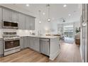 Open concept kitchen with stainless appliances and view to living room and outdoor patio at 1055 Piedmont Ne Ave # 409, Atlanta, GA 30309