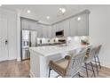 Bright kitchen with modern stainless steel appliances, sleek gray cabinets, quartz countertops and barstool seating at 1055 Piedmont Ne Ave # 409, Atlanta, GA 30309
