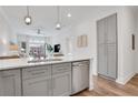 Stylish kitchen featuring an island with seating, stainless dishwasher, and view of living room at 1055 Piedmont Ne Ave # 409, Atlanta, GA 30309