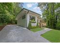 Exterior view of home with lush landscaping and a newly paved driveway at 1839 Belcher Pl, Austell, GA 30168