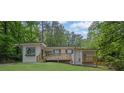 Beautiful house with a front porch, surrounded by mature trees and lush landscaping at 1839 Belcher Pl, Austell, GA 30168
