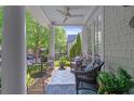 Cozy front porch featuring comfortable seating, a ceiling fan, and charming decor at 6575 Eli Davis Rd, Cumming, GA 30040