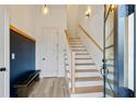 Bright foyer featuring wood floors, stairs, a chalkboard wall, and stylish light fixtures at 686 Exchange Se St, Atlanta, GA 30315