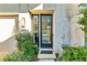 Contemporary front door with glass panels, a concrete facade, and lush landscaping at 686 Exchange Se St, Atlanta, GA 30315