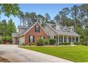 A delightful home with a brick facade and inviting front porch, set against a backdrop of lush greenery at 125 Murphy Creek Ln, Fayetteville, GA 30215