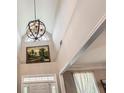 Bright foyer with a soaring ceiling, elegant light fixture, and neutral paint at 125 Murphy Creek Ln, Fayetteville, GA 30215