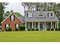 Inviting traditional home with a manicured lawn and a welcoming front porch at 125 Murphy Creek Ln, Fayetteville, GA 30215