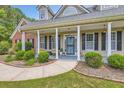 Inviting front porch with stylish columns, tasteful landscaping, and a decorative front door at 125 Murphy Creek Ln, Fayetteville, GA 30215