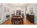 Formal dining room with hardwood floors, chandelier, and natural light at 1495 Old Hunters Lake Dr, Marietta, GA 30062