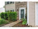 Close up of front door featuring a stone facade and manicured landscaping at 3230 Deer Valley Nw Dr, Acworth, GA 30101