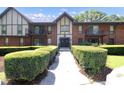 Brick apartment building showcasing landscaped bushes, a front walkway, and double door entry at 6851 Roswell Rd # H12, Atlanta, GA 30328