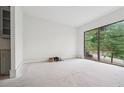 Brightly lit room with a large window overlooking green foliage at 1145 Kingston Drive, Atlanta, GA 30342