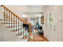 Bright foyer with hardwood floors, staircase with black iron railings, and views into the living room at 1434 Churchill Way, Marietta, GA 30062