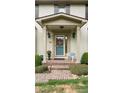 Inviting front porch featuring brick steps, decorative wreath, potted plants, and an elegant chair at 1434 Churchill Way, Marietta, GA 30062