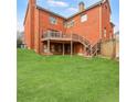 Brick home featuring a spacious backyard with a wooden deck and stairs at 1694 Jamie Leigh Ct, Snellville, GA 30078