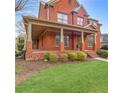 Charming brick front porch with classic columns and landscaped garden at 1694 Jamie Leigh Ct, Snellville, GA 30078