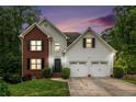 Charming two-story home with brick and siding, featuring an attached two-car garage and well-manicured lawn at 3073 Hopeland Dr, Powder Springs, GA 30127