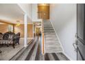 Inviting foyer with hardwood floors, staircase, and an open view into the living room and dining area at 3073 Hopeland Dr, Powder Springs, GA 30127