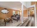Cozy living room featuring wood-look floors, large windows, a decorative mirror, and stylish furniture at 3073 Hopeland Dr, Powder Springs, GA 30127