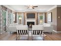 Stylish living room featuring a fireplace, large windows, and contemporary furniture at 323 Silver Leaf Trce, Douglasville, GA 30134