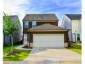 Rear view of this house highlighting the attached two car garage and paved driveway at 4734 Dewitt Dr, Duluth, GA 30097