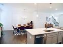 Sunlit open-concept kitchen featuring a dining area and hardwood floors at 4734 Dewitt Dr, Duluth, GA 30097