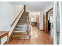 Inviting foyer with hardwood floors, staircase, and views into other rooms of the home at 558 Auburn Rd, Auburn, GA 30011