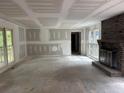 Spacious living room with a brick fireplace, large windows, and ample natural light at 2256 Mack Rd, Douglasville, GA 30135
