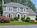 Charming gray two-story home with well-manicured lawn and mature landscaping at 2308 Littlebrooke Dr, Dunwoody, GA 30338