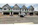 New townhomes under construction, showing garage doors and newly installed windows at 3104 Marbella Cir # 2, Kennesaw, GA 30152