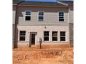 Back exterior of townhome featuring gray siding and brick details, several windows, and a back door at 3104 Marbella Cir # 2, Kennesaw, GA 30152